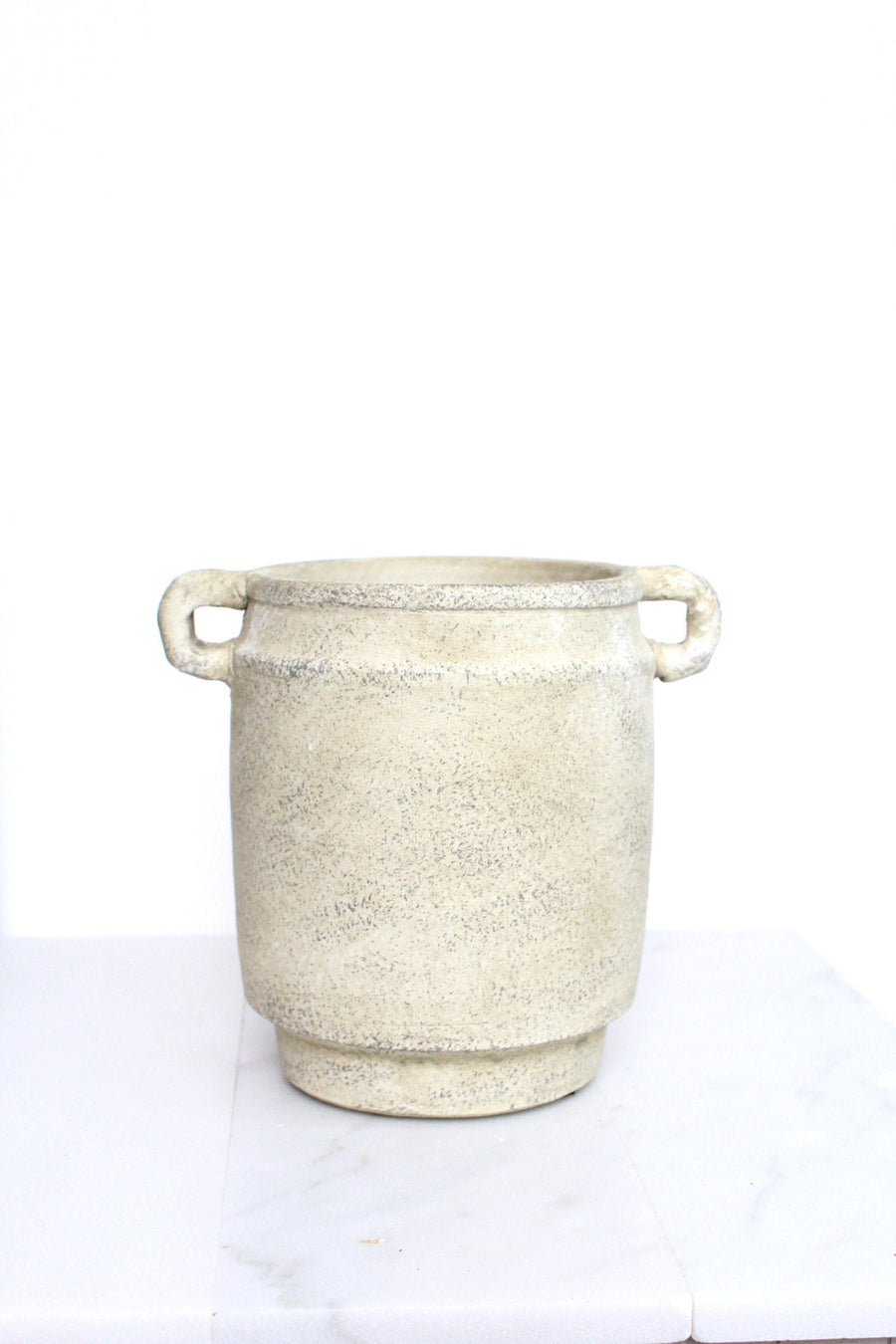 a white pot sitting on top of a table