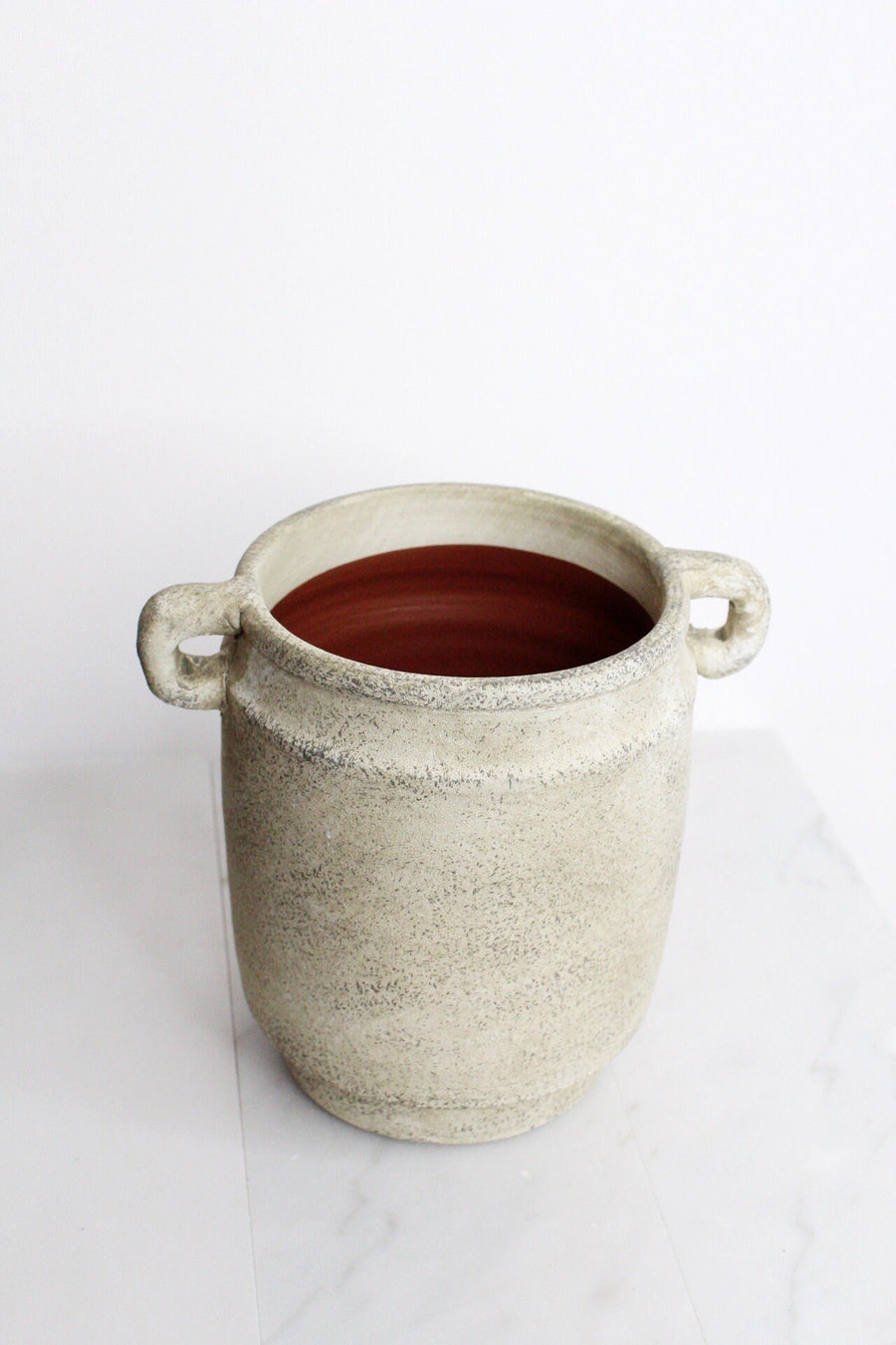 a white pot with a brown substance in it