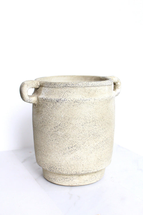 a white pot sitting on top of a table