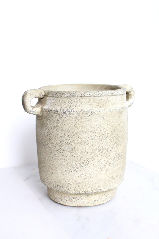 a white pot sitting on top of a table